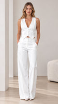 Front view of model wearing a white tailored V-neck vest and wide-leg trousers set