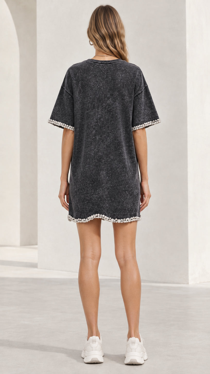 Back view of woman wearing washed black short sleeve t-shirt dress