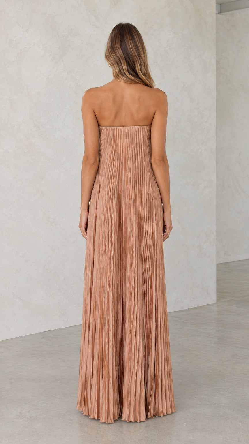 Back view of model showcasing the champagne strapless pleated maxi dress