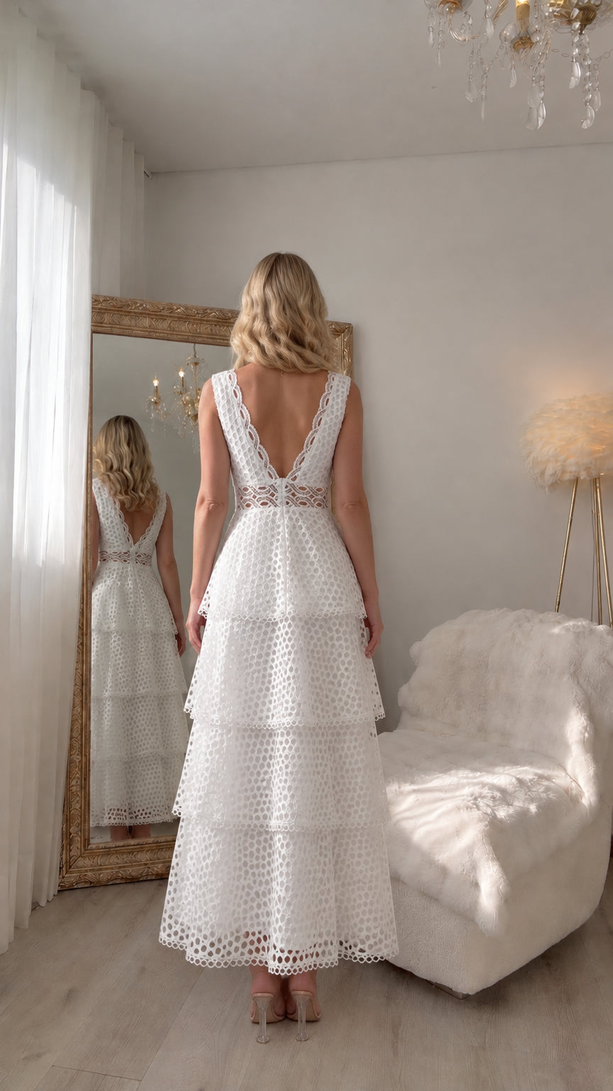 Back view of woman wearing white sleeveless lace dress with plunging V-back