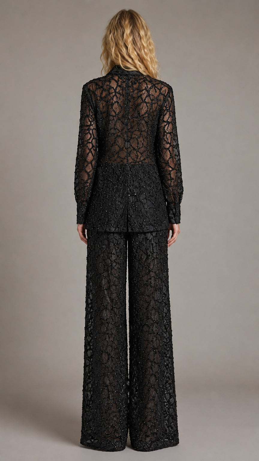 Back view of model wearing the black sheer sequin lace two-piece outfit