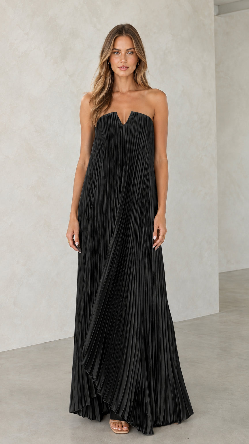 Model wearing black strapless pleated maxi dress with V-notch bodice