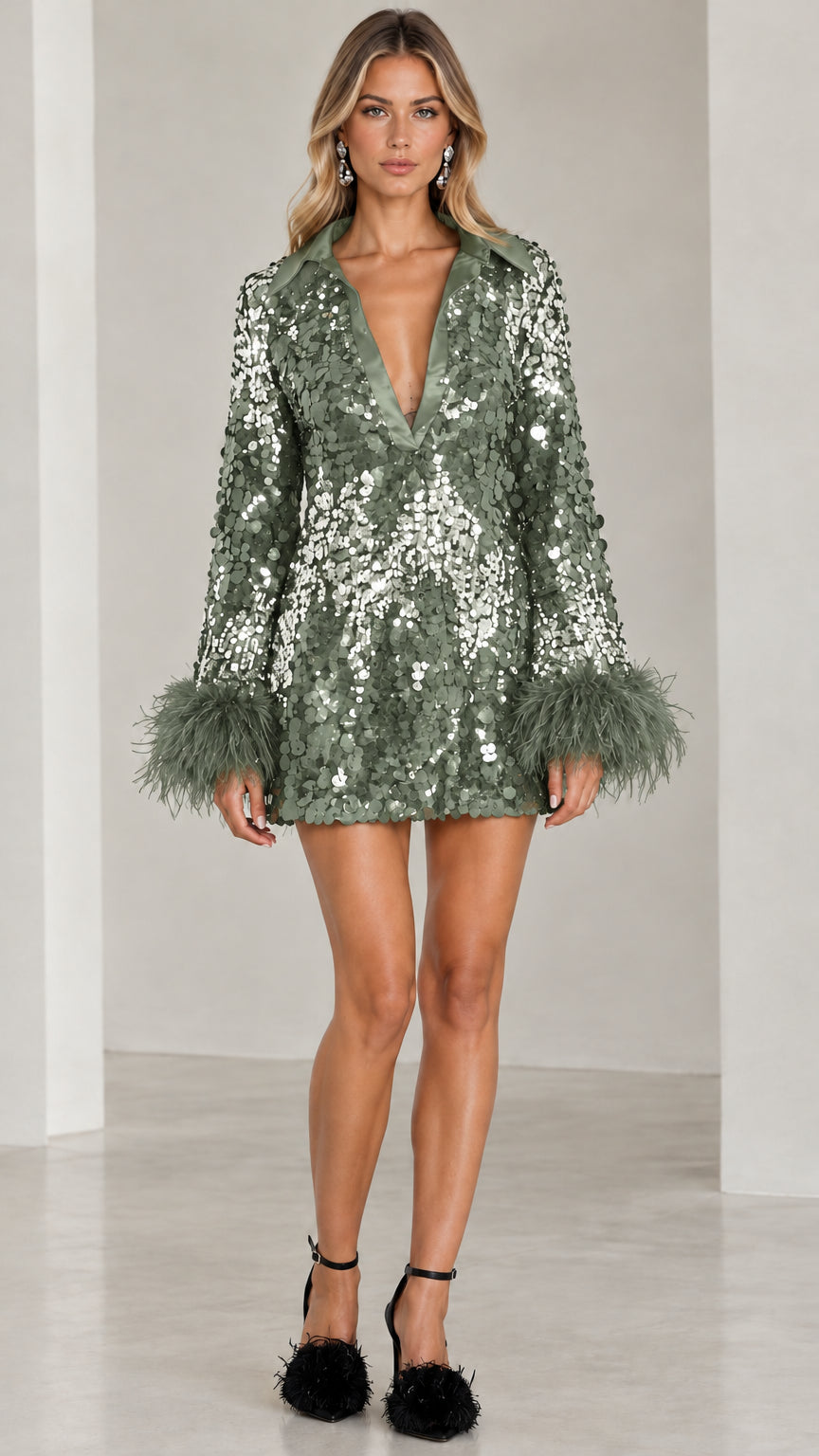 Model wearing sage green sequin plunge mini dress with matching green feather cuffs
